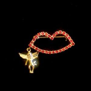 Costume jewelry with a lip, an angel hanging brooch. Silvertone